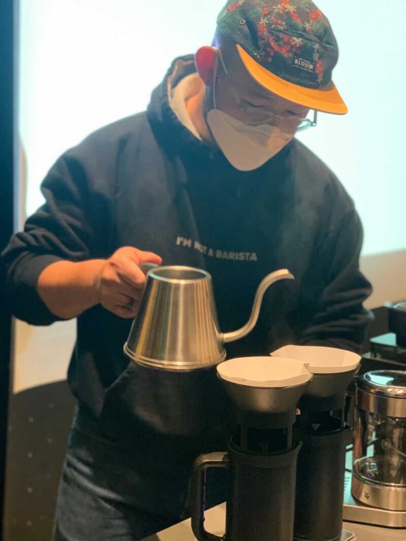 Youngjun Cho pouring coffee
